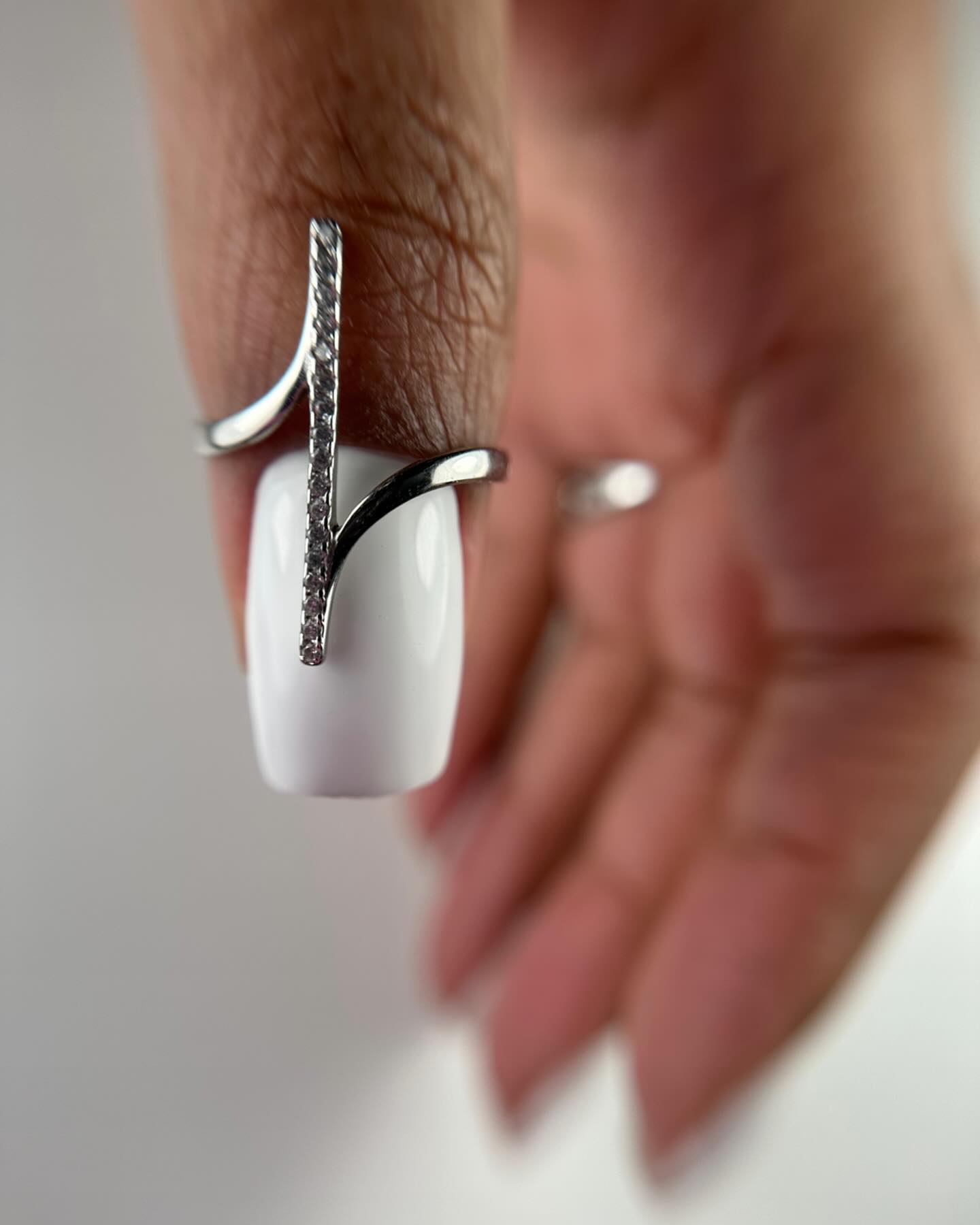 Chrome French manicure with luminous champagne tips.