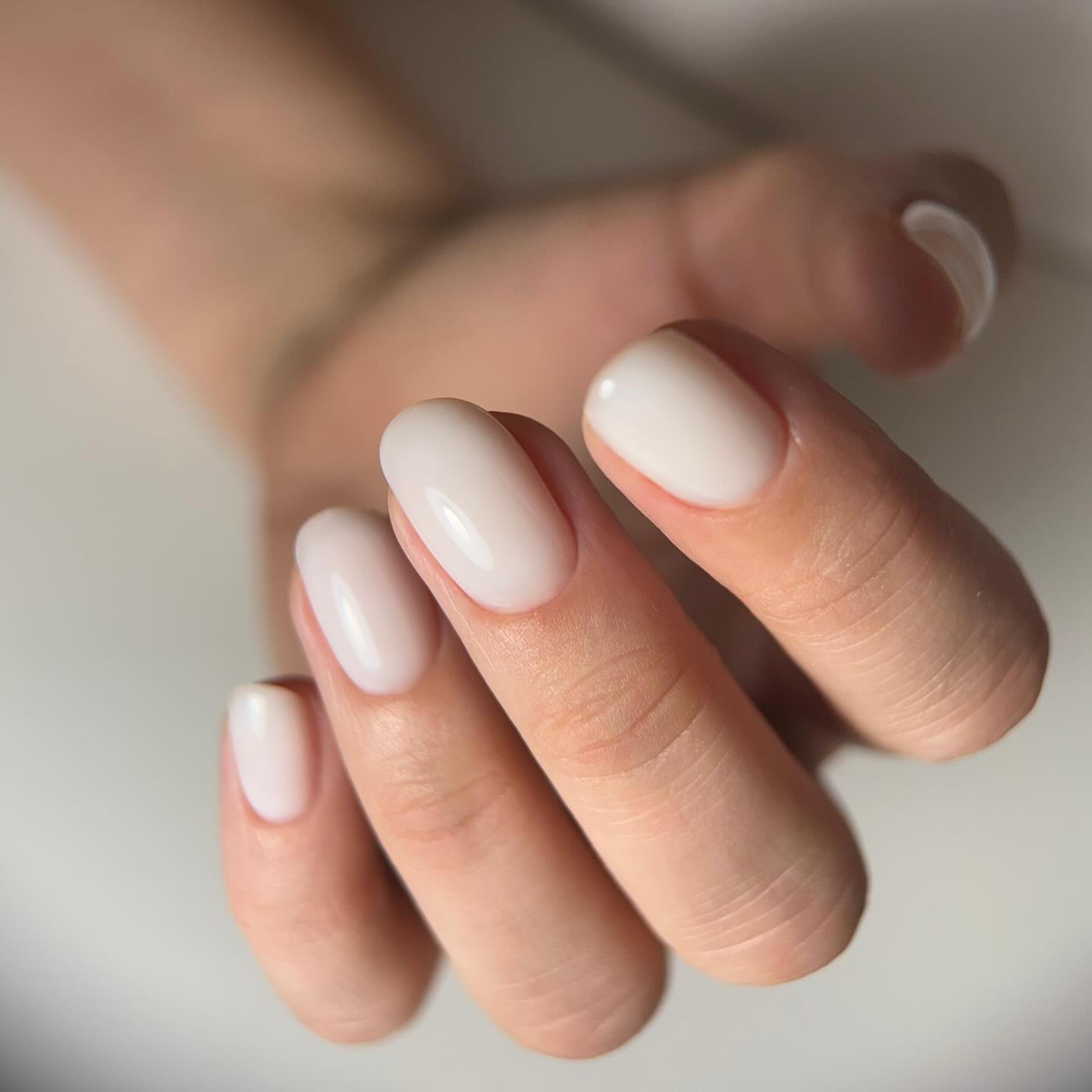 Crystal embellished manicure with blush and holographic accents.